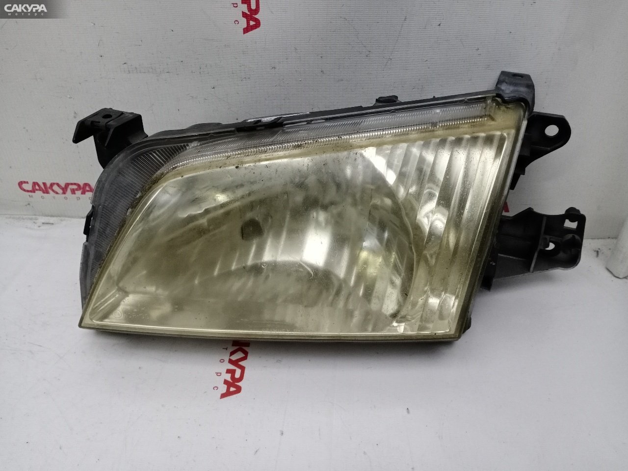 Фара левая Mazda Demio DW3W B3E P1001: купить в Сакура Красноярск.