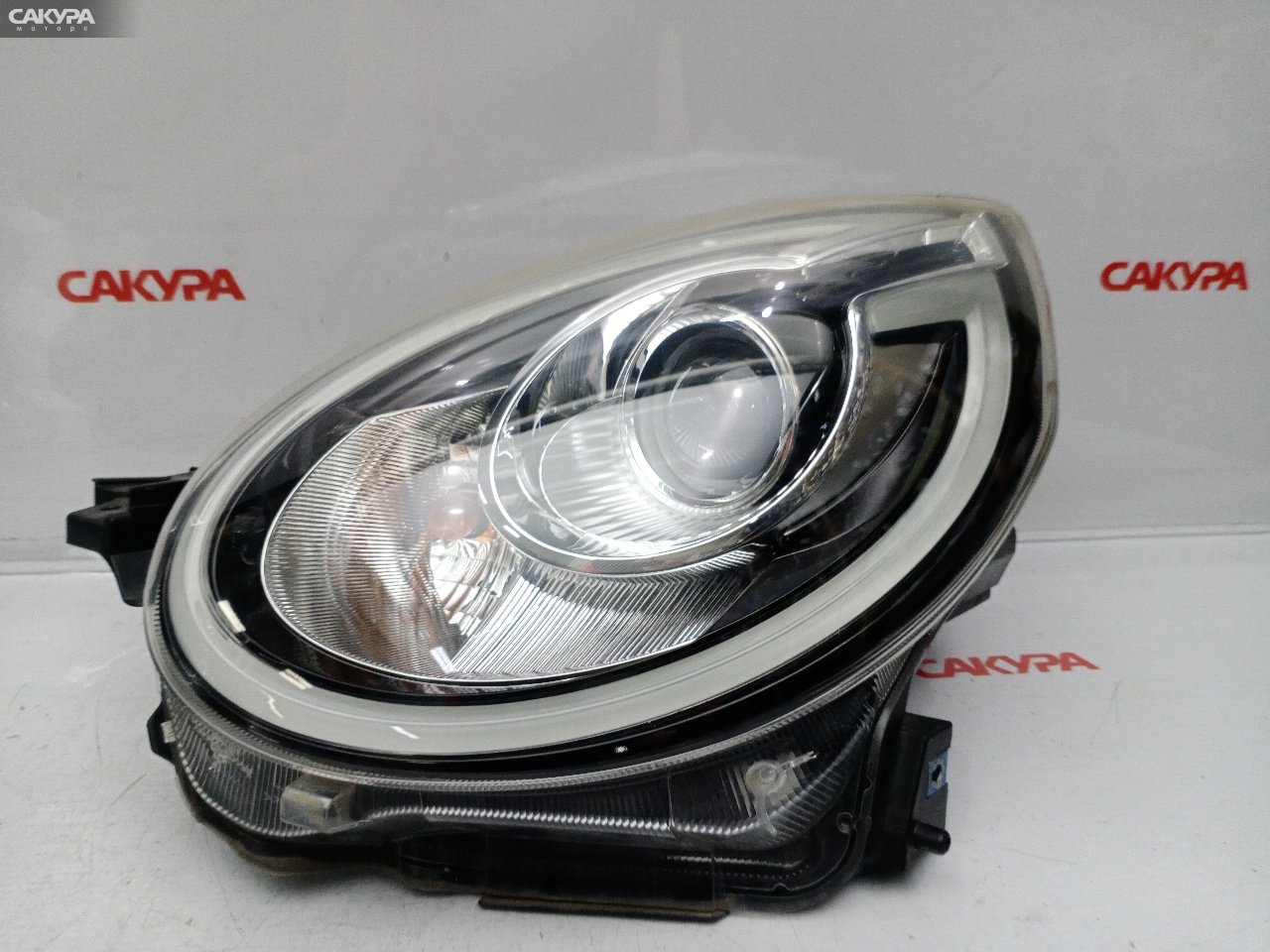 Фара левая Daihatsu Boon M700S 1KR-FE 100-69028: купить в Сакура Красноярск.