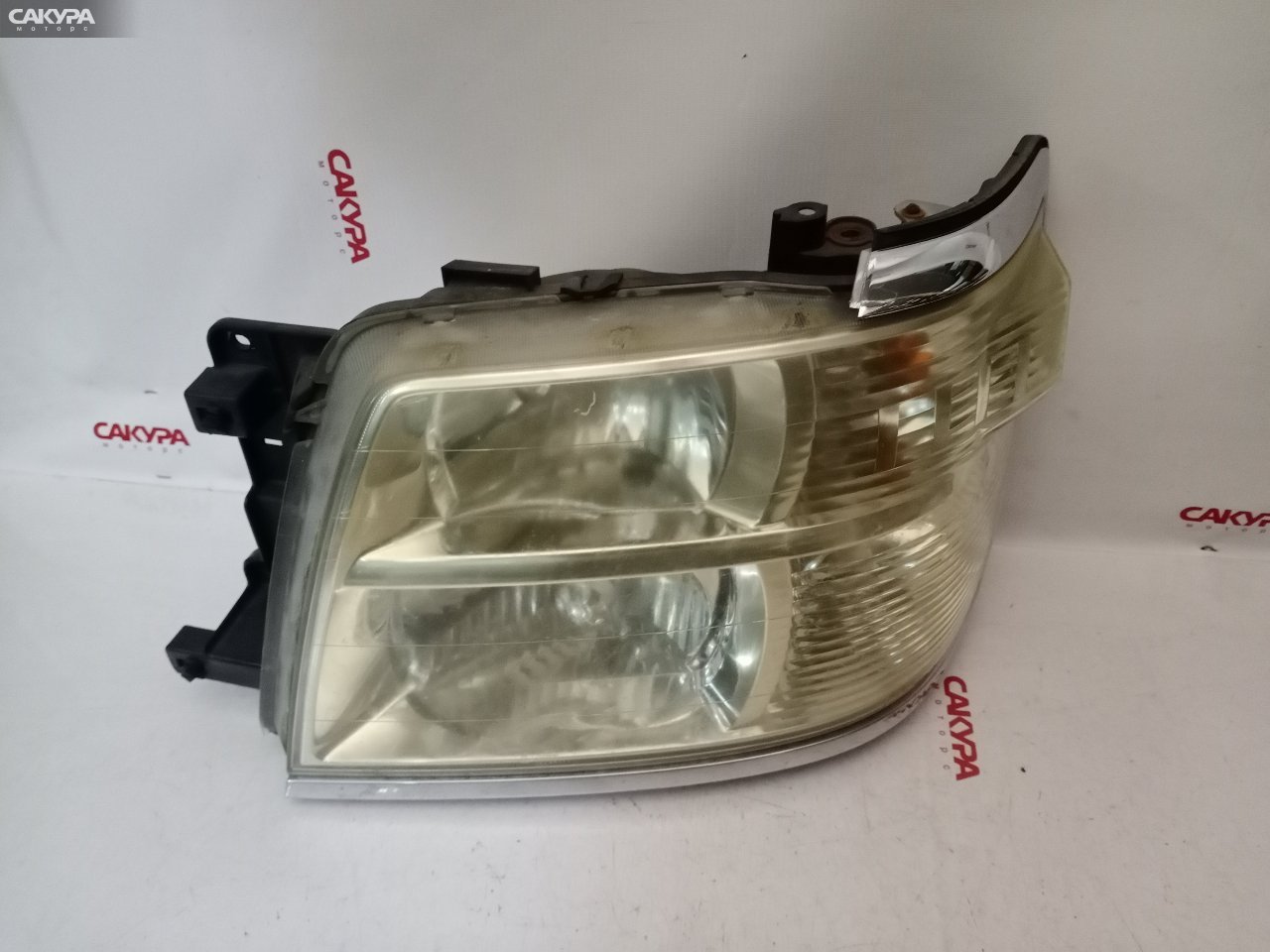 Фара левая Nissan Elgrand APWE50 100-24777: купить в Сакура Красноярск.