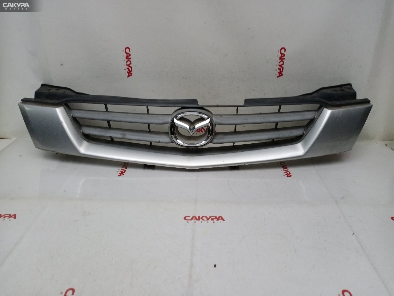 Решетка радиатора Mazda Demio DW3W B3E: купить в Сакура Красноярск.
