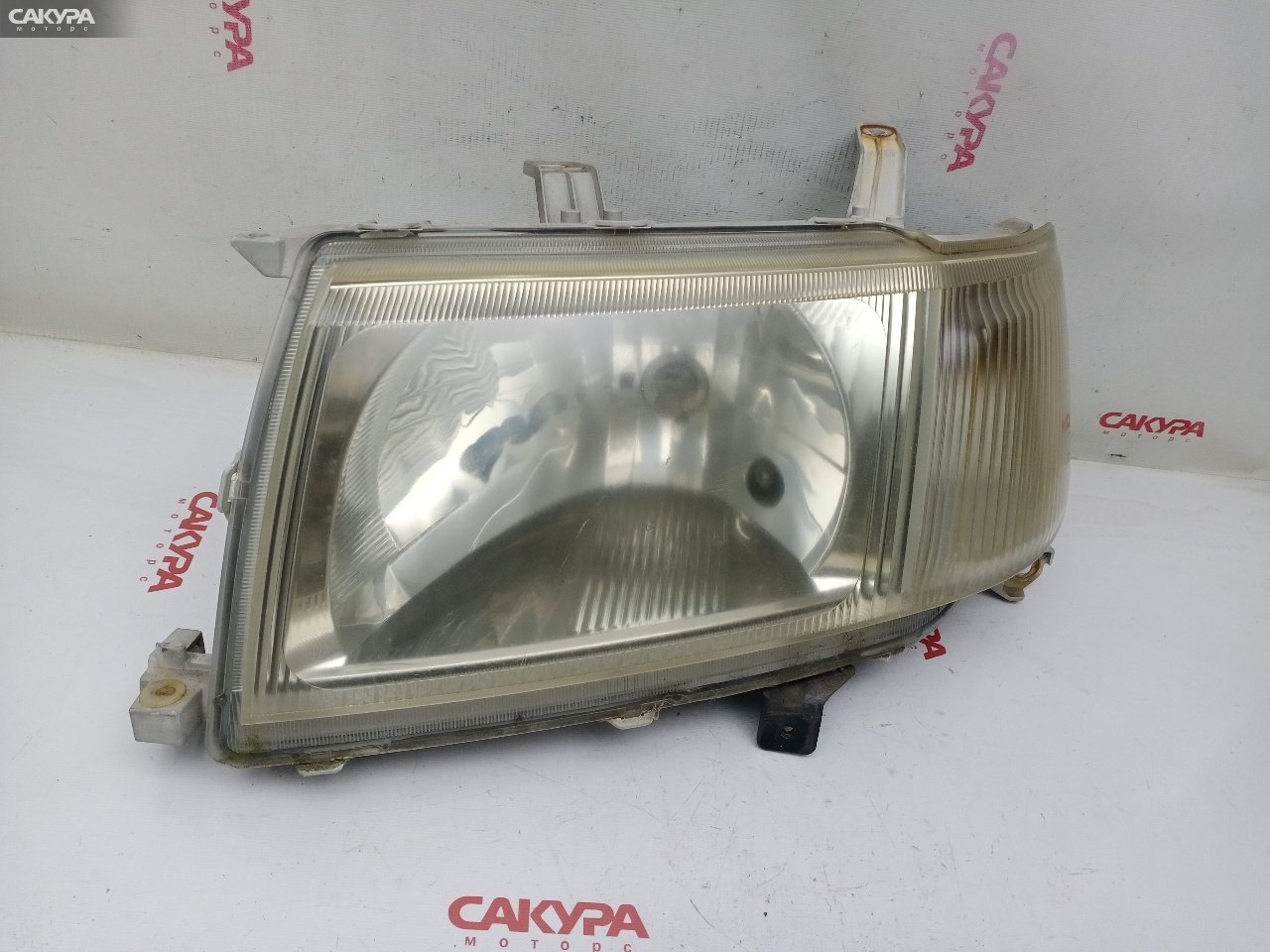 Фара левая Toyota Probox NCP51V 1NZ-FE 52-075: купить в Сакура Красноярск.