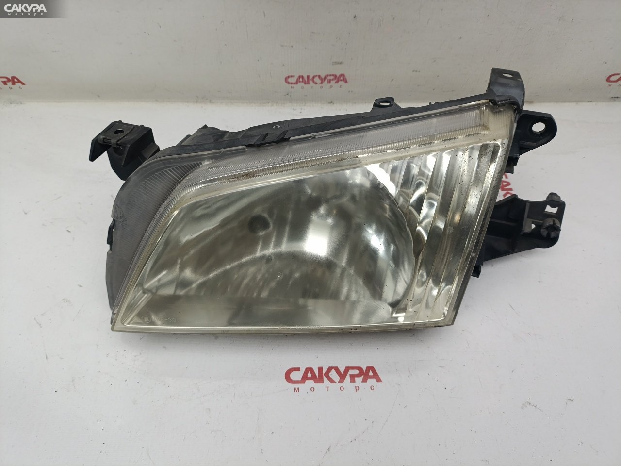 Фара левая Mazda Demio DW3W B3E P1001: купить в Сакура Красноярск.