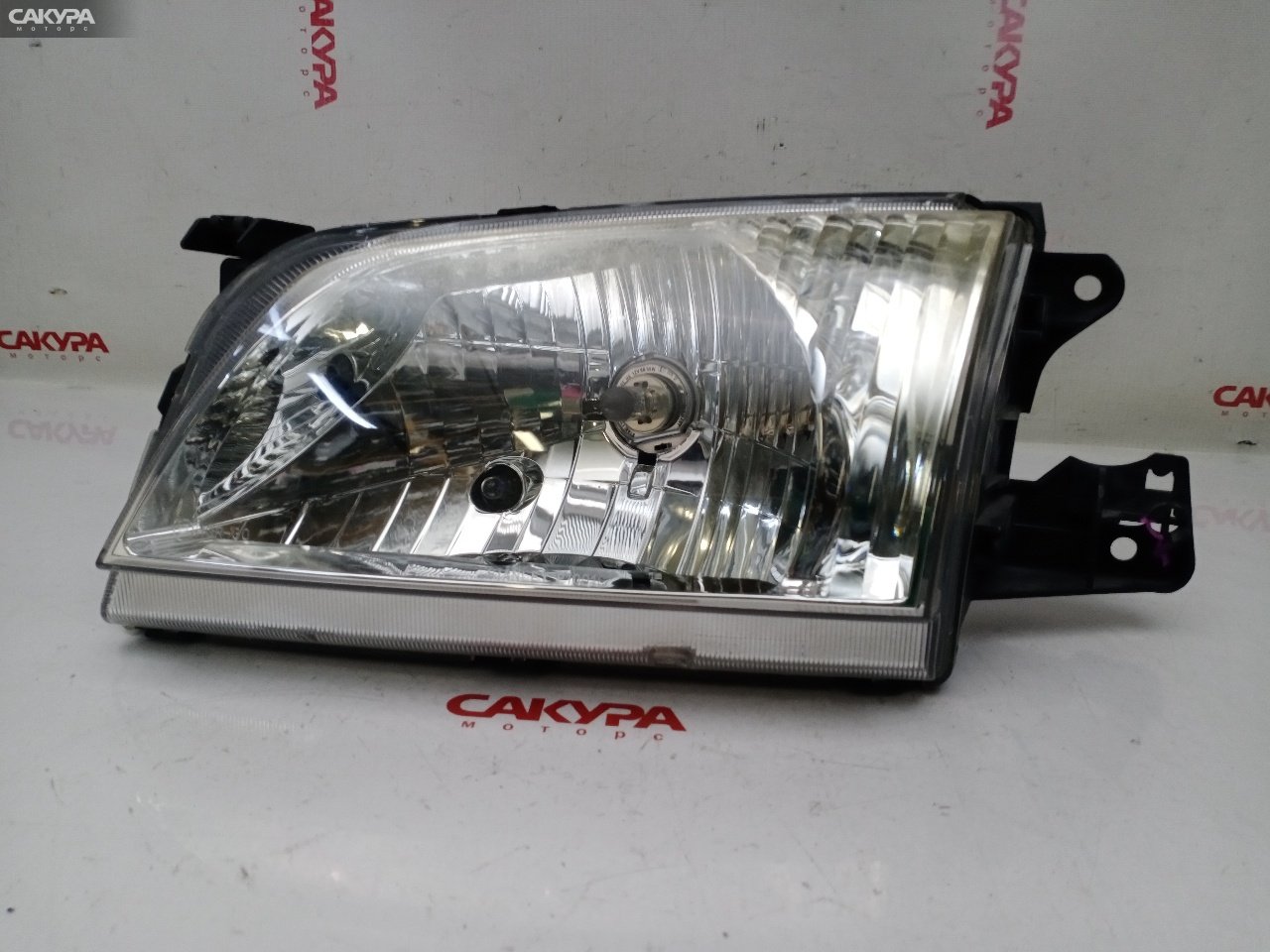 Фара левая Mazda Demio DW3W B3E P1001: купить в Сакура Красноярск.