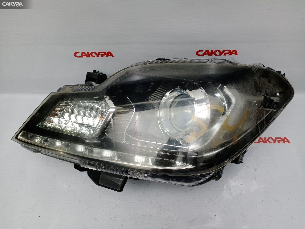 Фара левая Suzuki Solio MA15S K12B 100-59273: купить в Сакура Красноярск.