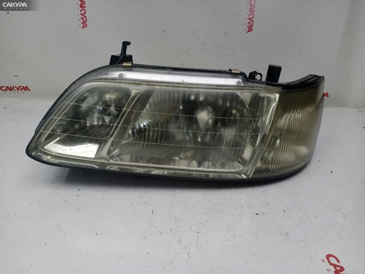 Фара левая Nissan Laurel HC35 RB20DE 100-66255: купить в Сакура Красноярск.